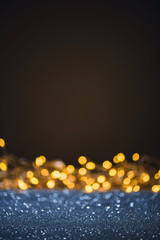 Wall Mural - selective focus of blurred sparkling lights and bokeh on black