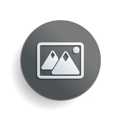 Poster - Picture with couple of mountains and sun. Simple icon. White paper symbol on gray round button or badge with shadow