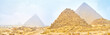 Panorama of Giza pyramid complex in foggy morning, Egypt