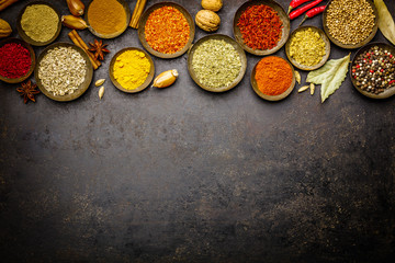 Wall Mural - Various bowls of spices over dark background