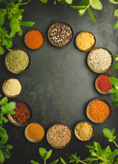 Wall Mural - Various bowls of spices over dark background