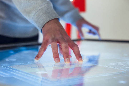 Hand interacting with large touch screen