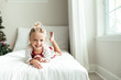 © Samantha McBride - Smiling young girl lying on a bed