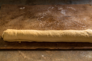 Wall Mural - cinnamon buns - Cinnabon cooking process raw dough. (food background). copy space