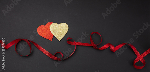 Top View Of Red And Golden Hearts With Ribbon Black Background