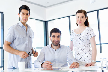 Wall Mural - Group of happy young business people in a meeting