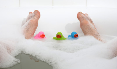 Wall Mural - Men's feet in a bathtub, selective focus on toes