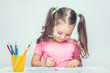 © Myst - beautiful cute little girl holding pencil in mouth and drawing picture on white paper