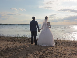 Wall Mural - Wedding, the couple looks to the future. Summer on the beach