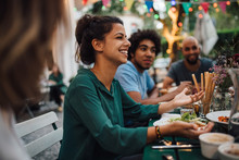 Smiling Woman Gesturing During Party In Backyard