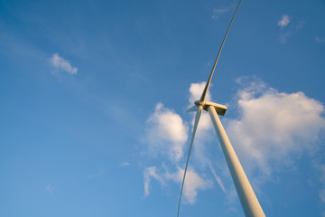 Wind turbine farm or windmill on blue sky. Turbine green energy electricity or wind turbine in a green field - Energy Production with clean and Renewable Energy. Phan Rang, Vietnam