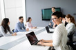 © NDABCREATIVITY - Group of lawyers discussing contract together in office