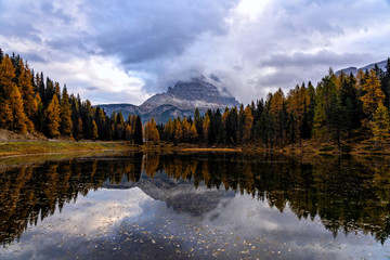 Wall Mural - Autumn landscape of Antorno lake with famous Dolomites mountain peak of Tre Cime di Lavaredo in background in Dolomites, Italy. Beautiful nature scenery and scenic travel destination in Fall time.