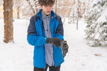 man hands put on warm gloves on a winter cold day f