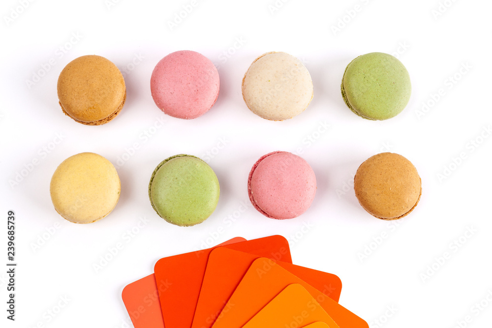 French macarons and red orange color swatches on white background - obrazy, fototapety, plakaty 