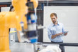 © Westend61 - Businessman checking industrial robot in high tech company