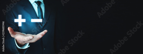 Fotomural Man holding plus and minus signs. Business concept