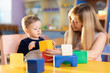 © Oksana Kuzmina - Child boy together with mother playing educational toys at sunny day in nursery