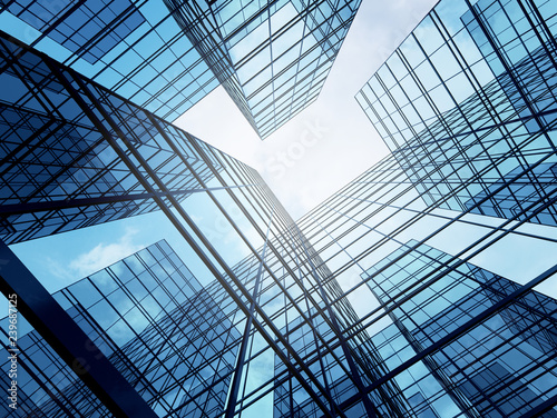 Cuadros en Lienzo View of high rise glass building and dark steel window system on blue clear sky background,Business concept of future architecture,looking up to the sun light on the top of building