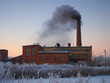 © kozorog - Old brick factory building. Black smoke from the pipe