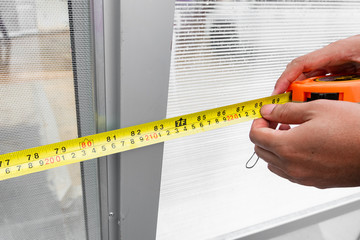 hand holding measurement tape and measuring