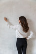 © ADDICTIVE STOCK - Elegant woman writing on cement wall