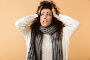 Sticker - Confused young woman wearing winter scarf