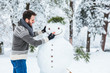 © marjan4782 - Young man making snowman in the park