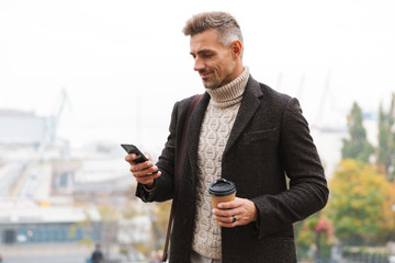 Wall Mural - Attractive man wearing jacket walking