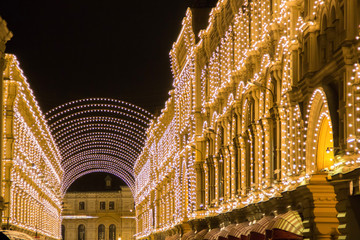 Wall Mural - Magic lights garland illumination on christmas holidays in central Moscow area in the evening. Bottom view