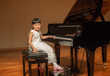 © dul_ny - Little girl in white dress on stage with grand piano