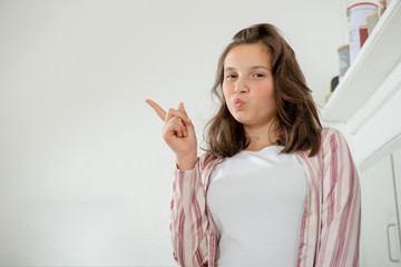 pretty teenage girl showing with a finger