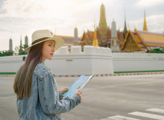 Welcome To Thailand. Portrait charming beautiful traveler woman. Young asian woman traveling to Grand Palace, Wat Phra Kaew with pleared feeling on holiday.