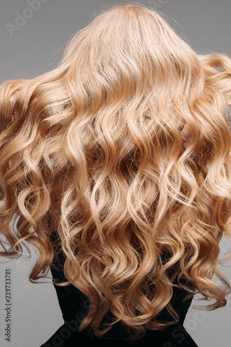 Back View Of Unrecognizable Woman In Black With Volumous Blonde