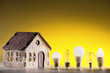 Silhouette led lamps against layout of the house on a yellow background