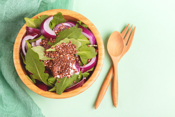 Healthy salad with fresh spinach, red onion and flax seeds