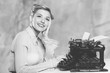 © BillionPhotos.com - Attractive young woman working on vintage typewriter