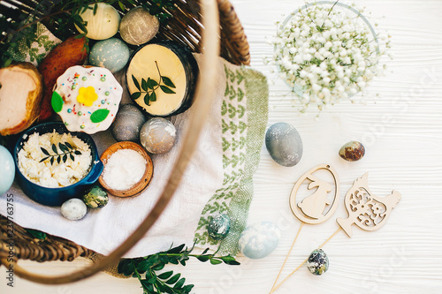 Easter Basket With Stylish Eggs Easter Bread Ham Sausage Butter And Flowers Easter Wooden Bunny And Chicken Decorations On Rustic Wood Top View Happy Easter Concept Buy This Stock Photo And