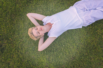 Sticker - top view of young woman relaxing on the grass