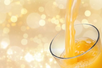 Poster - Orange juice pouring in glass on background