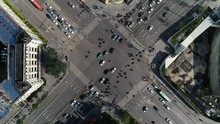 Overhead Drone Shot Of Police Officer Guiding Traffic Over Busy Intersection In Central Kunming City In China