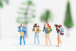 © Sirichai Puangsuwan - Miniature people : Traveler with backpack walking on whitebackground ,
