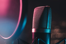 Colourful Mic In Studio Setting - Close Up Macro Shot Of Microphone In Studio Glowing With Colorful Lights With Strong Lens Flare Awaits A Singer
