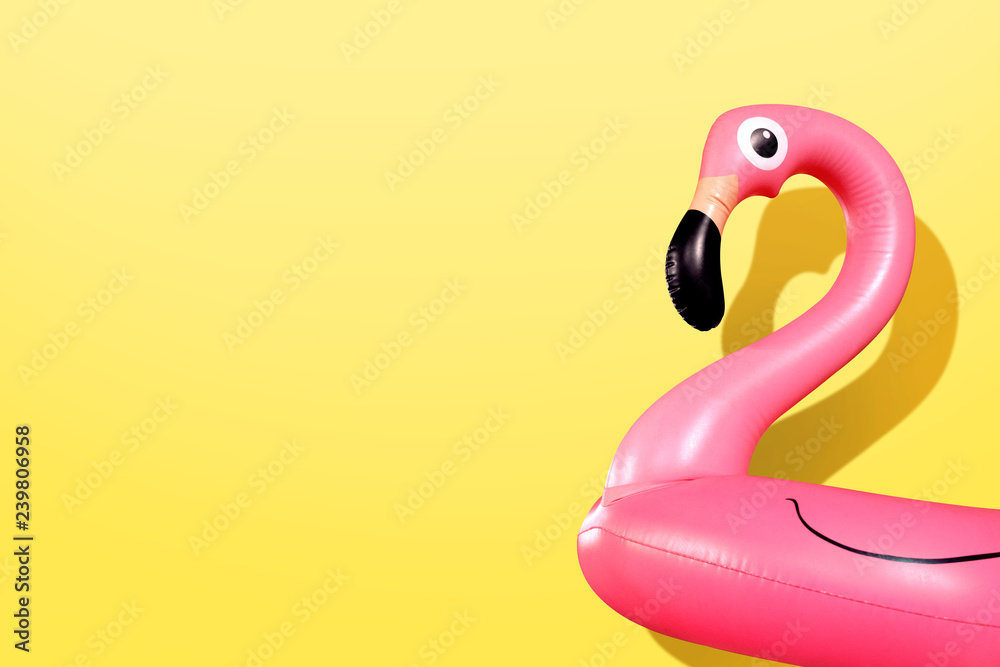 Giant inflatable Flamingo on a yellow background, pool float party, trendy summer concept - obrazy, fototapety, plakaty 