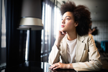 Young woman with afro hairstyle smiling in urban background