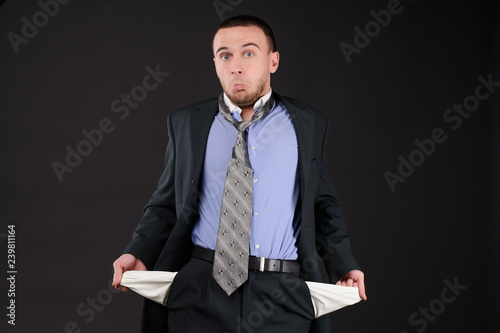 Fotomural businessman turning his empty pockets inside out after tax audit or collector visit