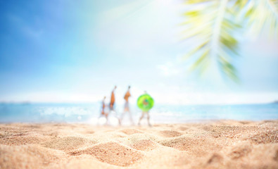Wall Mural - Blur defocused background, nature of tropical summer beach with rays of sun light and happy family silhouettes. Sand beach, sea, palm leaves against blue sky. Copy space, summer vacation concept.