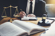 Male lawyer or judge working with contract papers, Law books and wooden gavel on table in courtroom, Justice lawyers at law firm, Law and Legal services concept