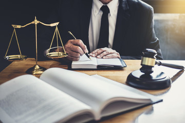 Wall Mural - Male lawyer or judge working with contract papers, Law books and wooden gavel on table in courtroom, Justice lawyers at law firm, Law and Legal services concept