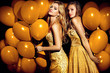 © ASjack - Two sexy girls in golden balloons. Celebrating.